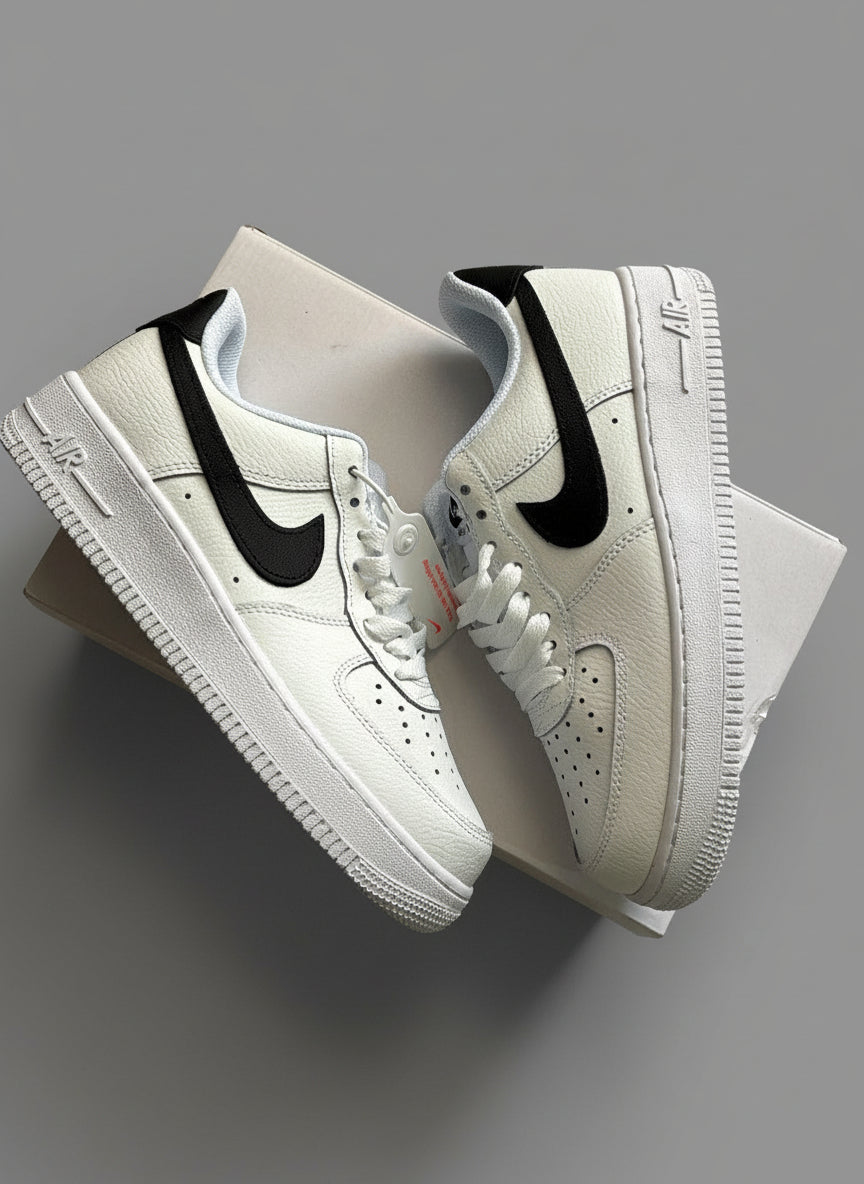 White sneakers with black swoosh logo on a textured surface