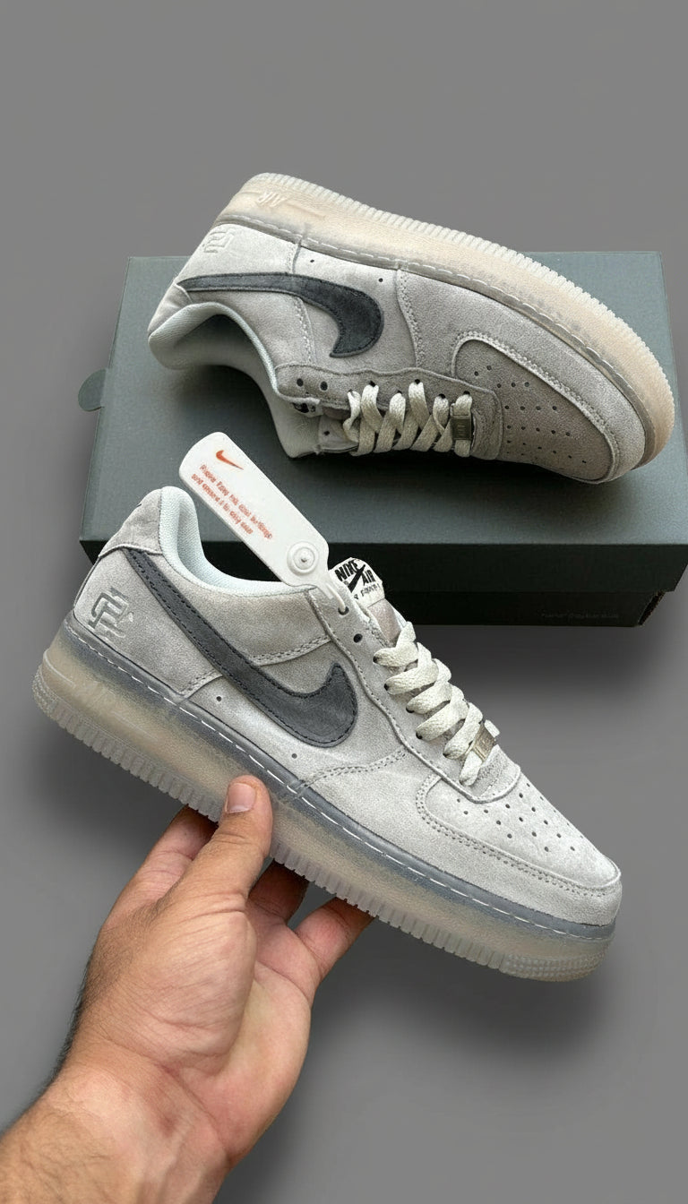 Gray sneakers with a Nike logo on a wooden surface