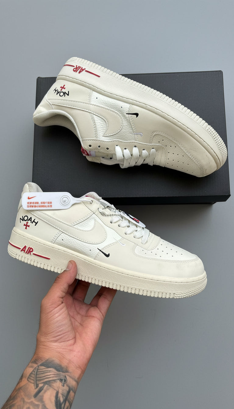 White sneakers with branding on a dark surface