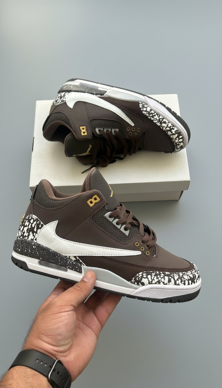 Brown sneakers with white soles on a wooden surface