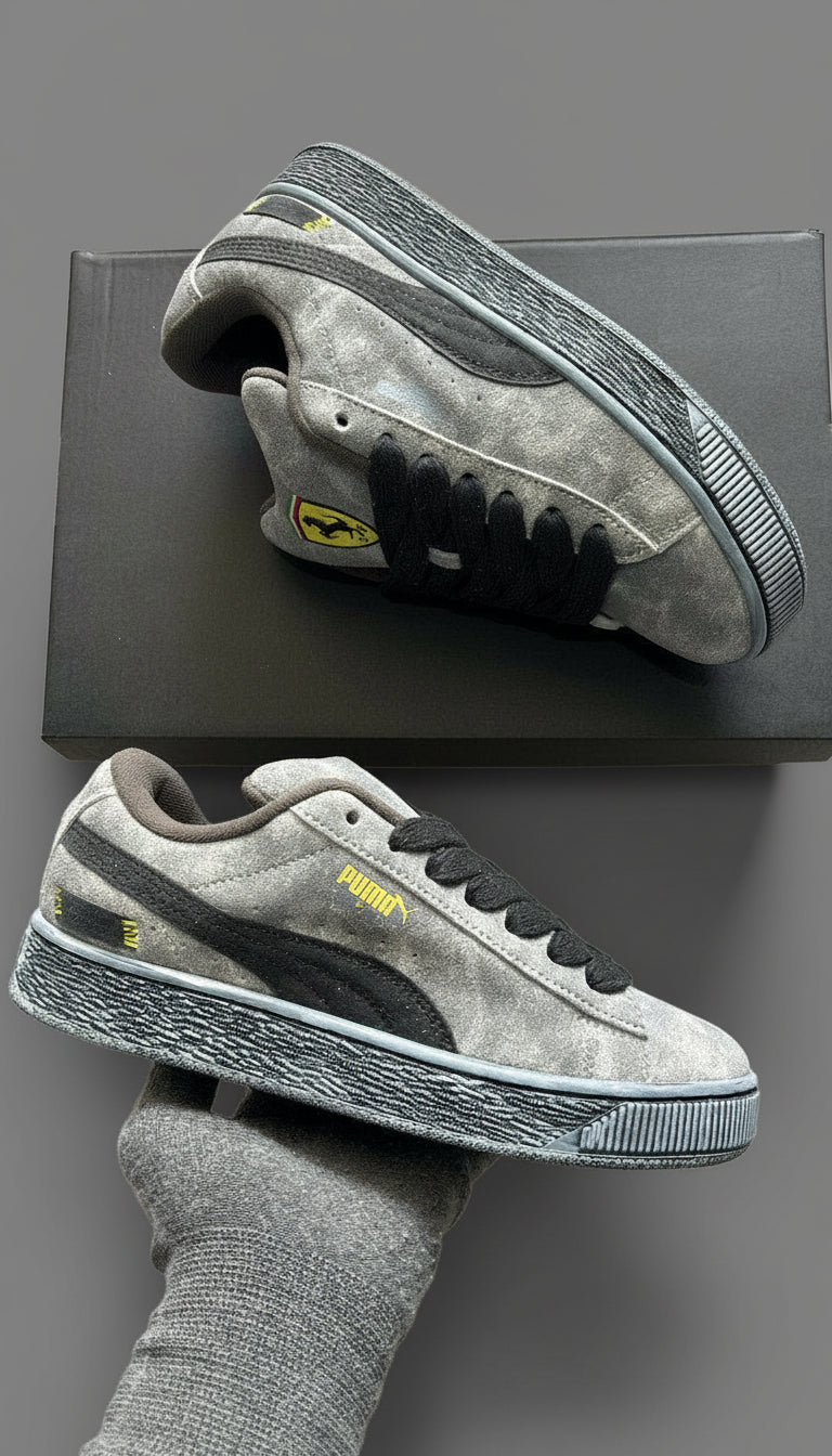 Gray sneakers with black accents on a textured surface