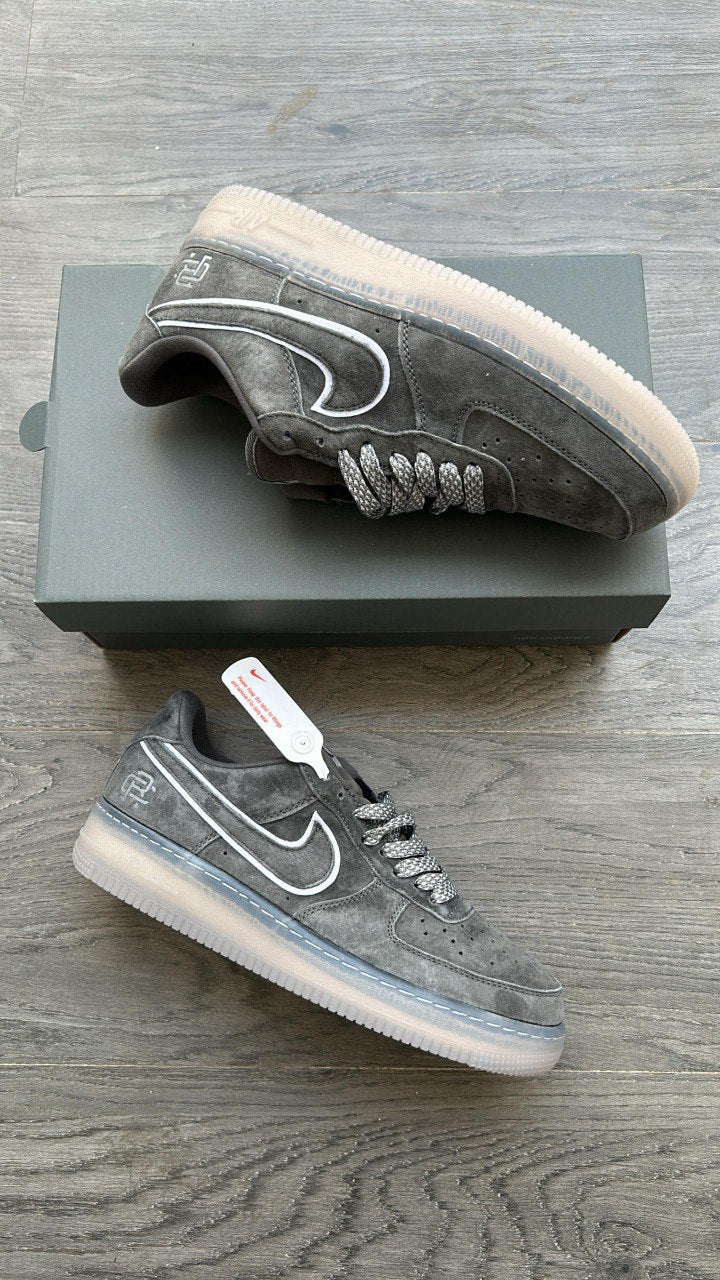 Gray sneakers with white soles on a wooden surface